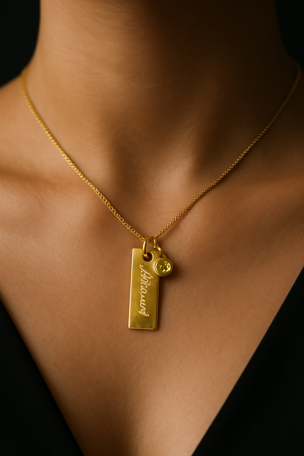 Engraved plate name necklace with green birthstone charm on gold finish—972 sterling silver, customizable chain length.
