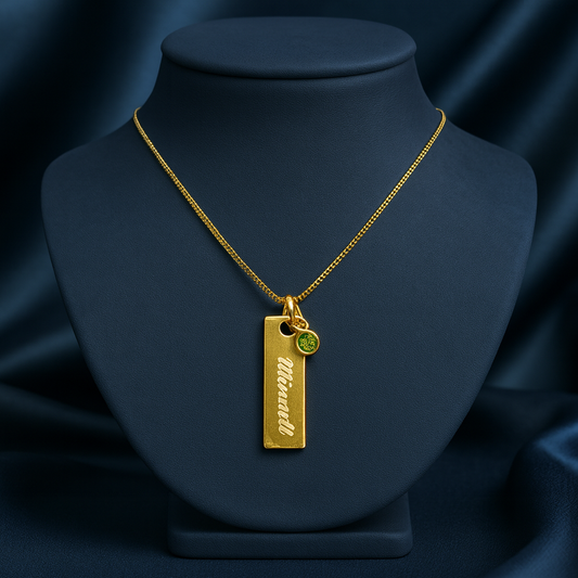 Engraved plate name necklace with green birthstone charm on gold finish—972 sterling silver, customizable chain length.